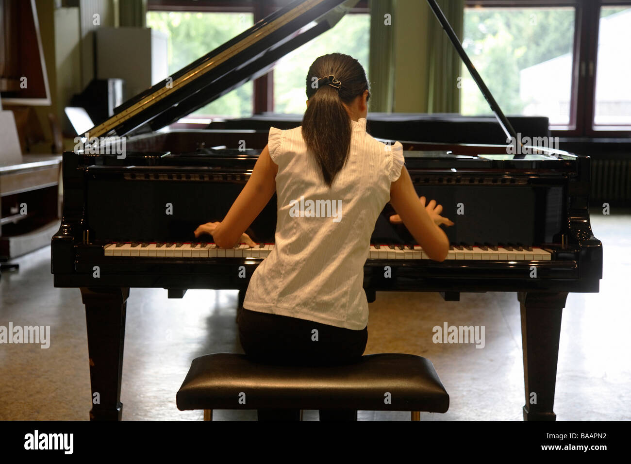 Young student practising piano at Robert Schumann Music College, Duesseldorf, Germany Stock Photo