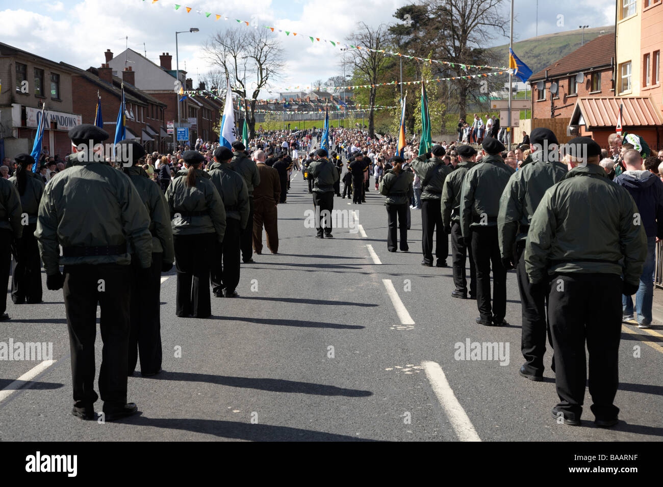 marchers in jackets and trousers march on Easter Sunday as part of the Easter Rising Commemoration Falls Road Belfast Stock Photo