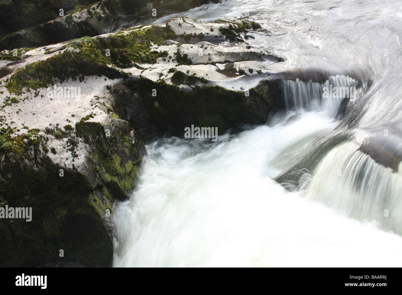 Moving milky water at Swallow Falls, Betws-Y-Coed, Snowdonia, Wales. Stock Photo