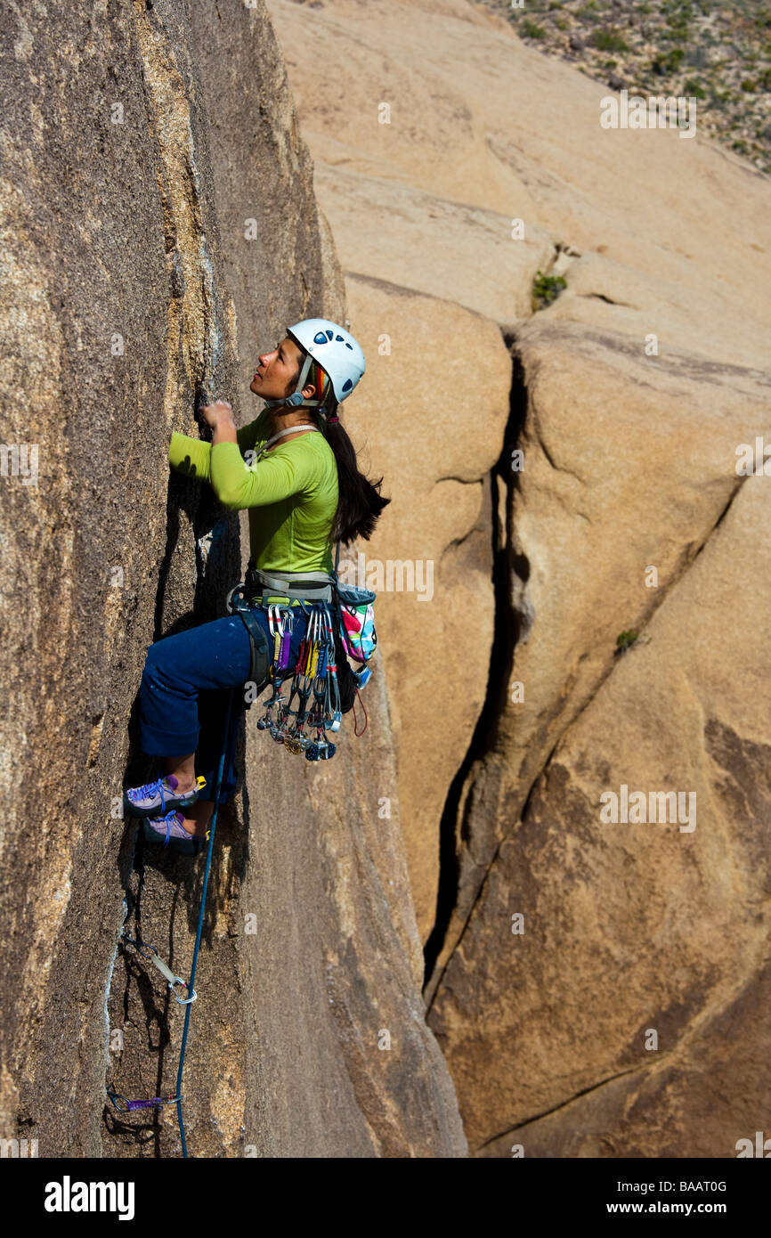 Female rock climber clings to the side of cliff Stock Photo Alamy