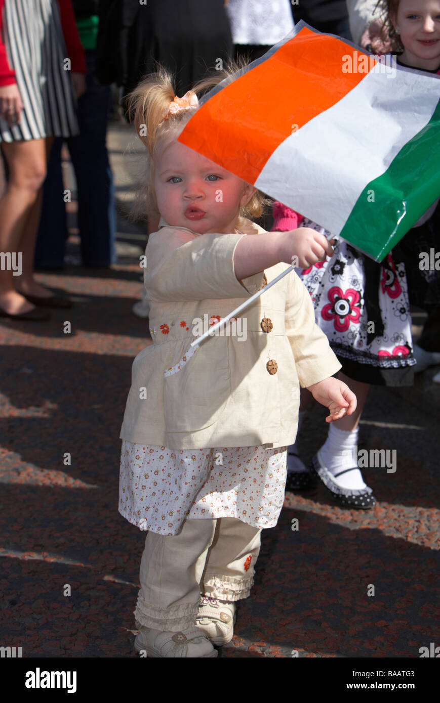 young toddler girl waving an irish tricolour flag on Easter Sunday ...