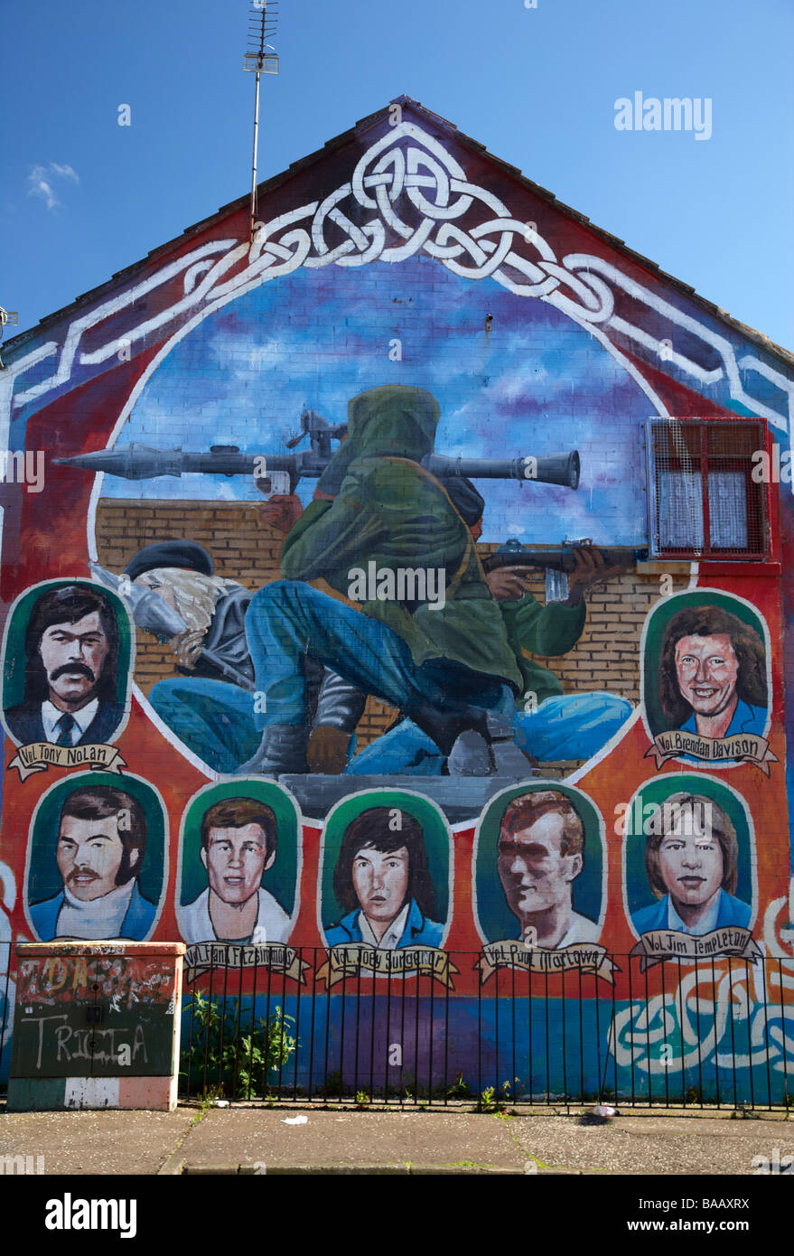 IRA republican mural showing dead volunteers and IRA RPG rocket attack in progress painted in the markets area of belfast Stock Photo