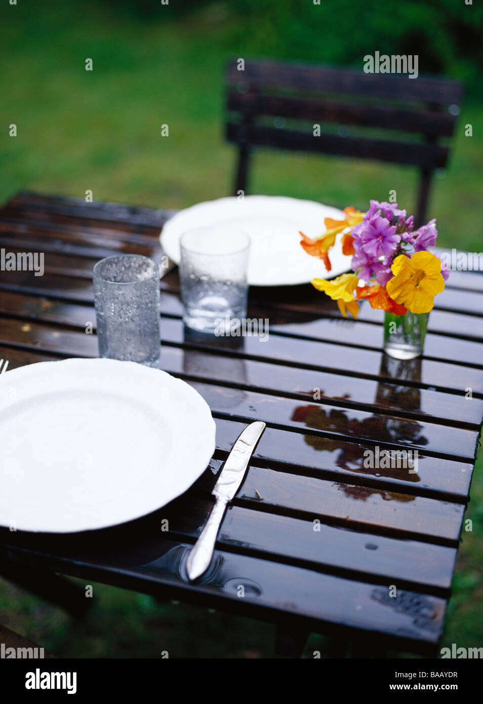 Raining on a table ready laid, Sweden. Stock Photo