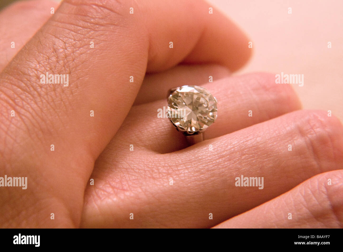 Couple's hands displaying engagement ring Stock Photo