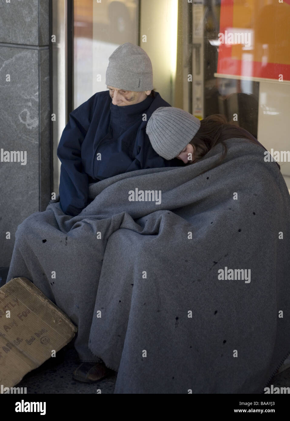 Homeless couple wrapped in a blanket on the street in New York City in ...