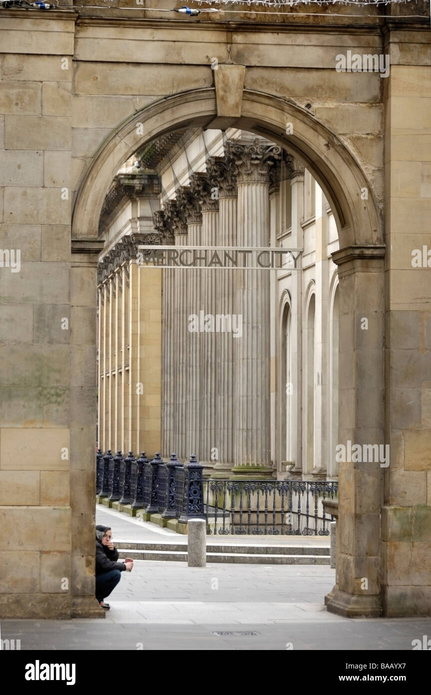 Photograph of beggar outside gates into the Merchant City Glasgow Scotland Stock Photo