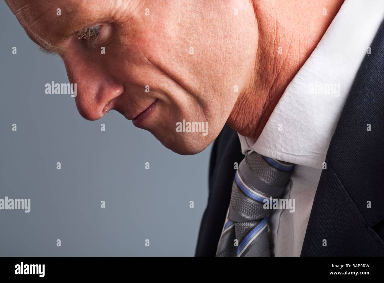 Portrait of businessman with head hung in shame Stock Photo