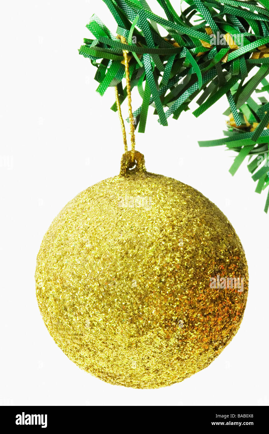 Golden bauble hanging on a Christmas tree Stock Photo