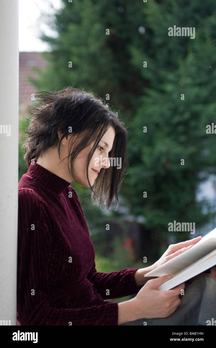 Woman reading a book outside - Frau liest ein Buch im Freien Stock Photo