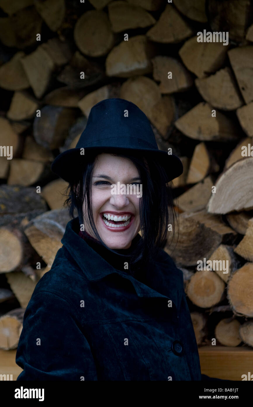 Woman in front of firewood - Frau vor einem Stapel Brennholz Stock Photo