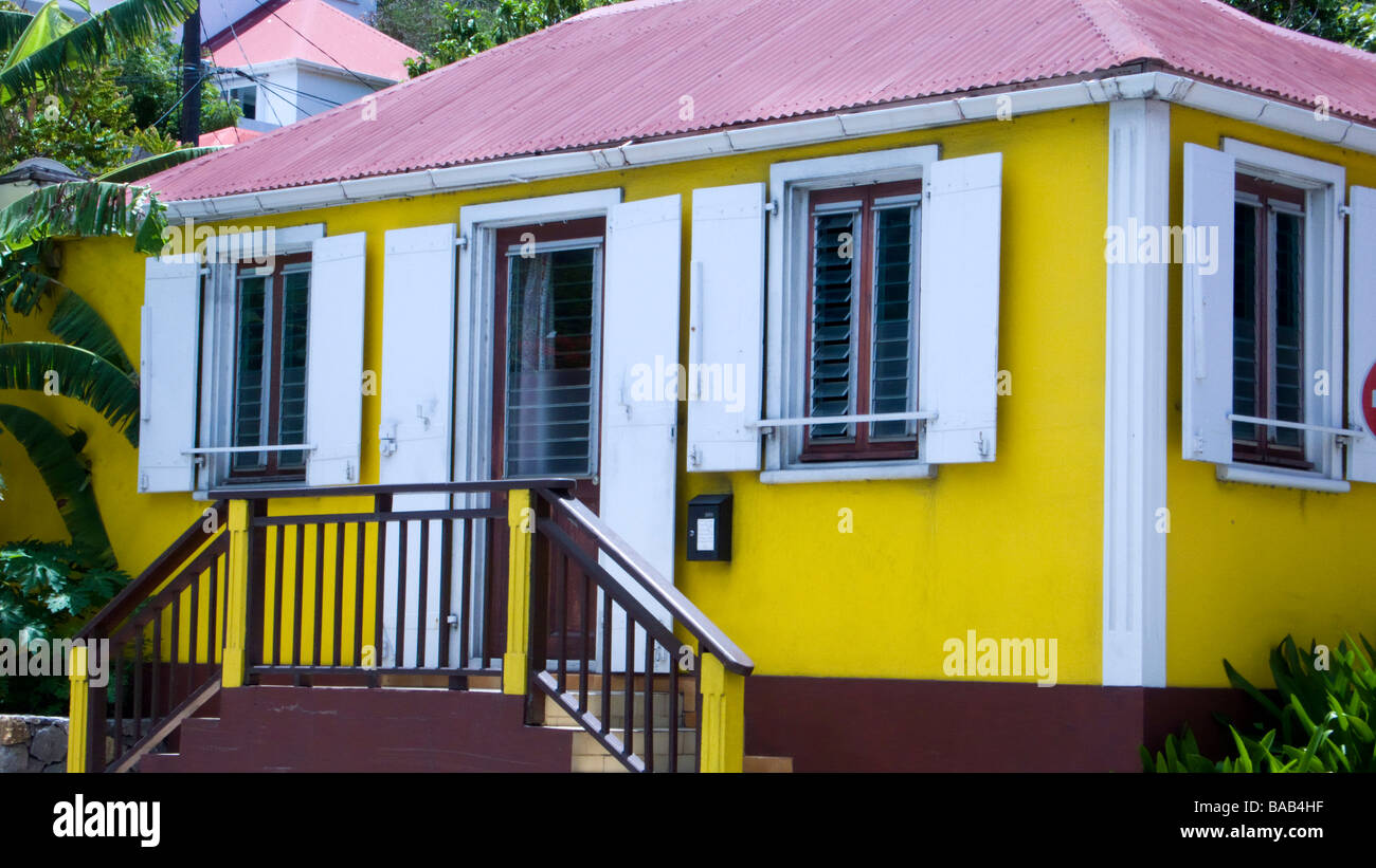Traditional yellow home with shutters and red tin roof Gustavia St Barts Stock Photo
