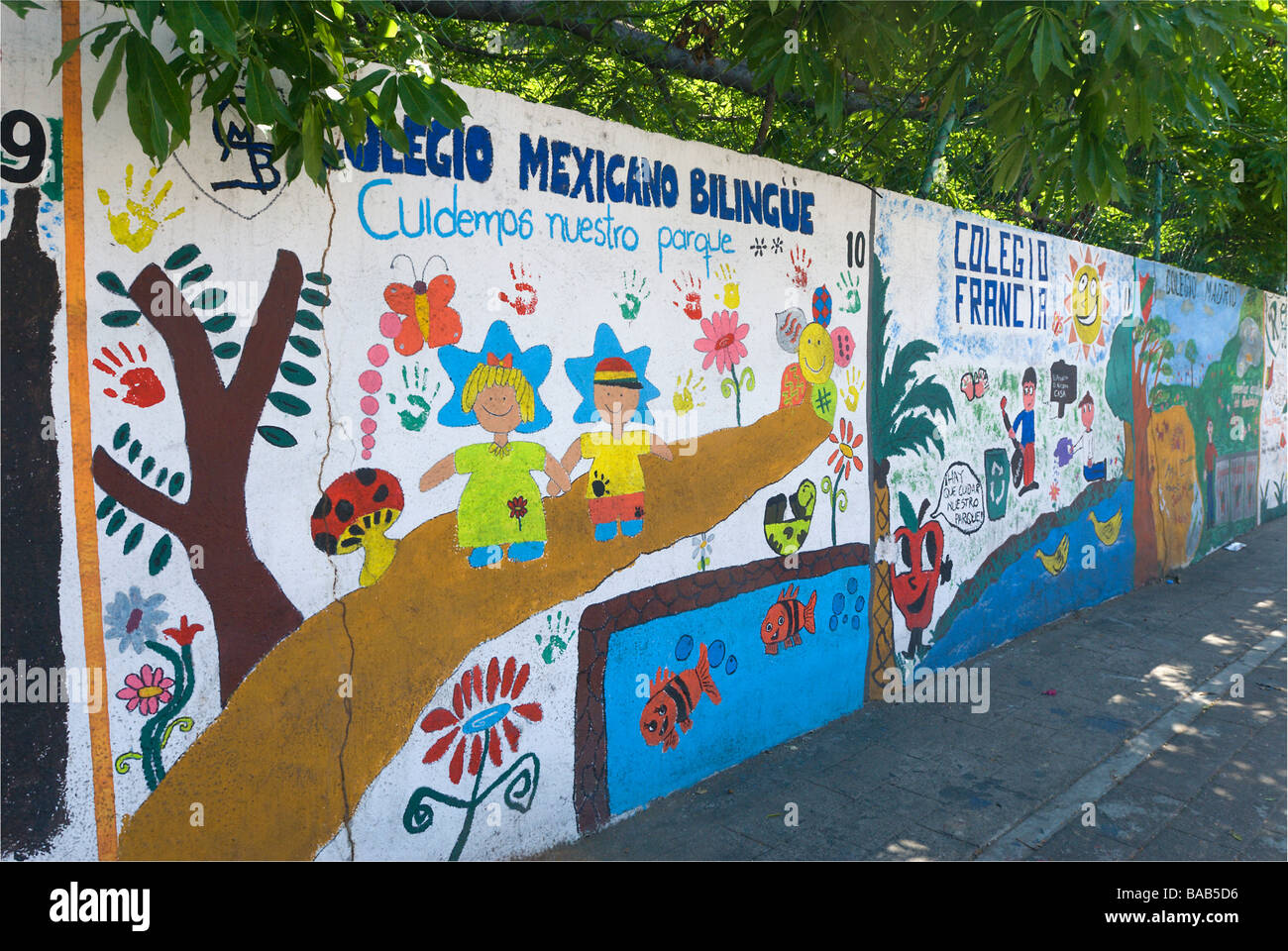 Spanish language mural for schools on wall surrounding Parque Papagayo in Acapulco, Mexico Stock Photo