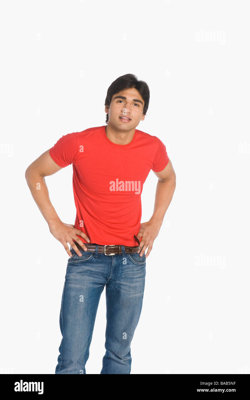 Portrait of a man standing with arms akimbo Stock Photo - Alamy