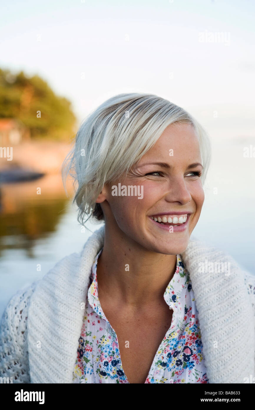 A woman by the sea in the archipelago of Stockholm, Sweden Stock Photo
