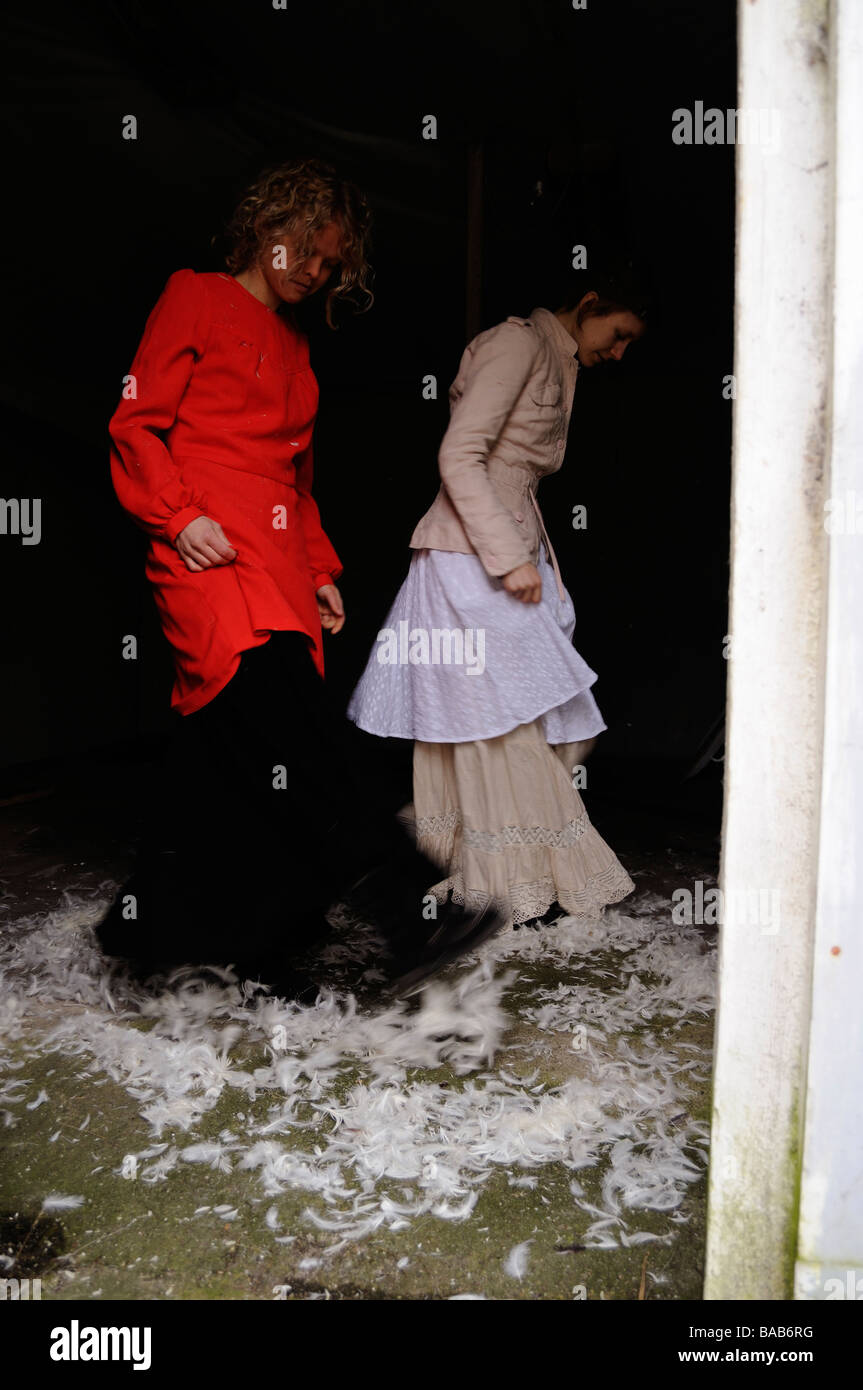 Two Young Women Throwing Down From A Down Pillow In An Old House Stock Photo Alamy