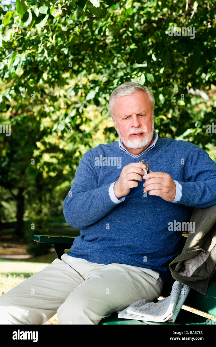 Old men sitting on benches hi-res stock photography and images - Alamy
