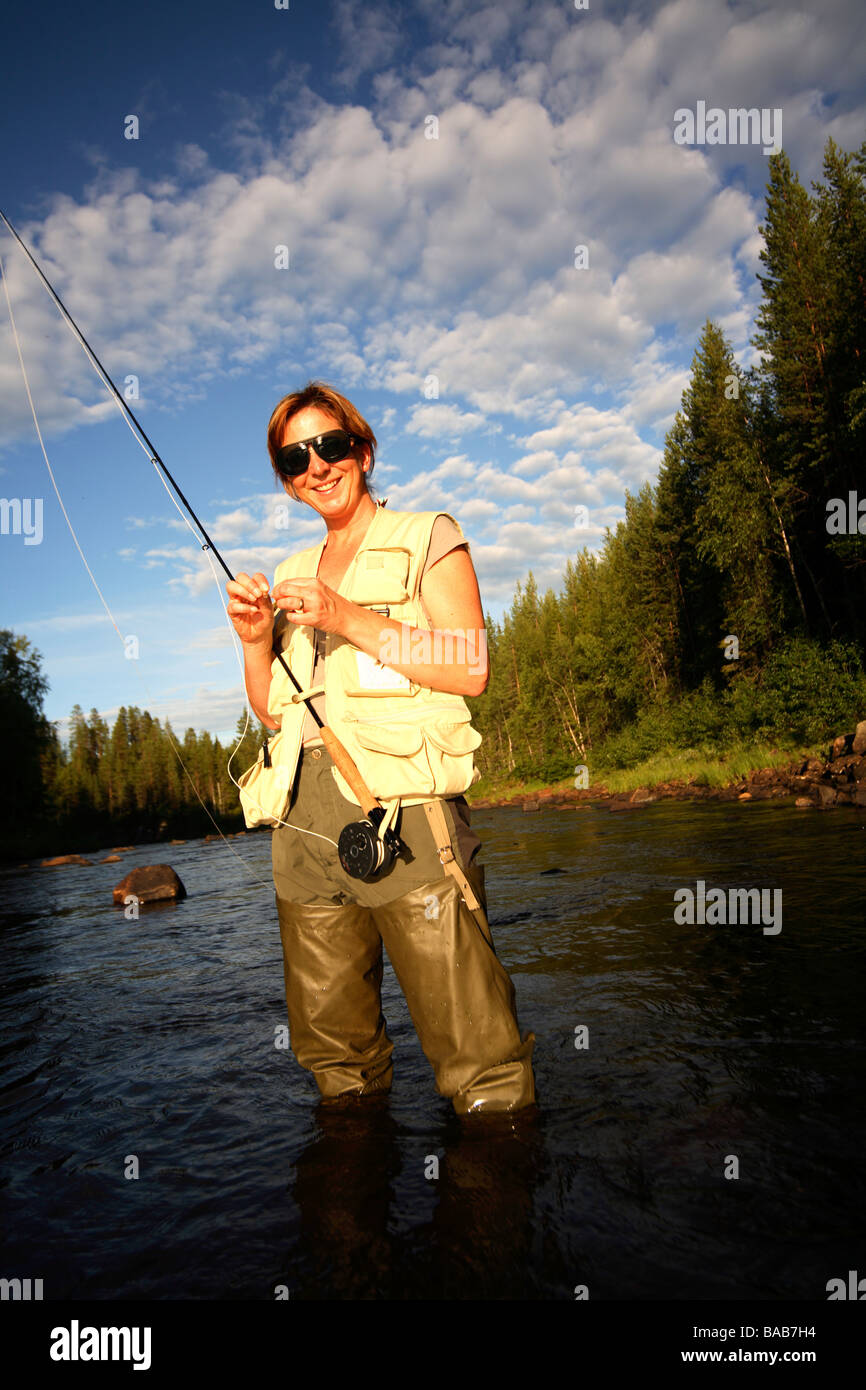 A woman fly-fishing Sweden Stock Photo - Alamy