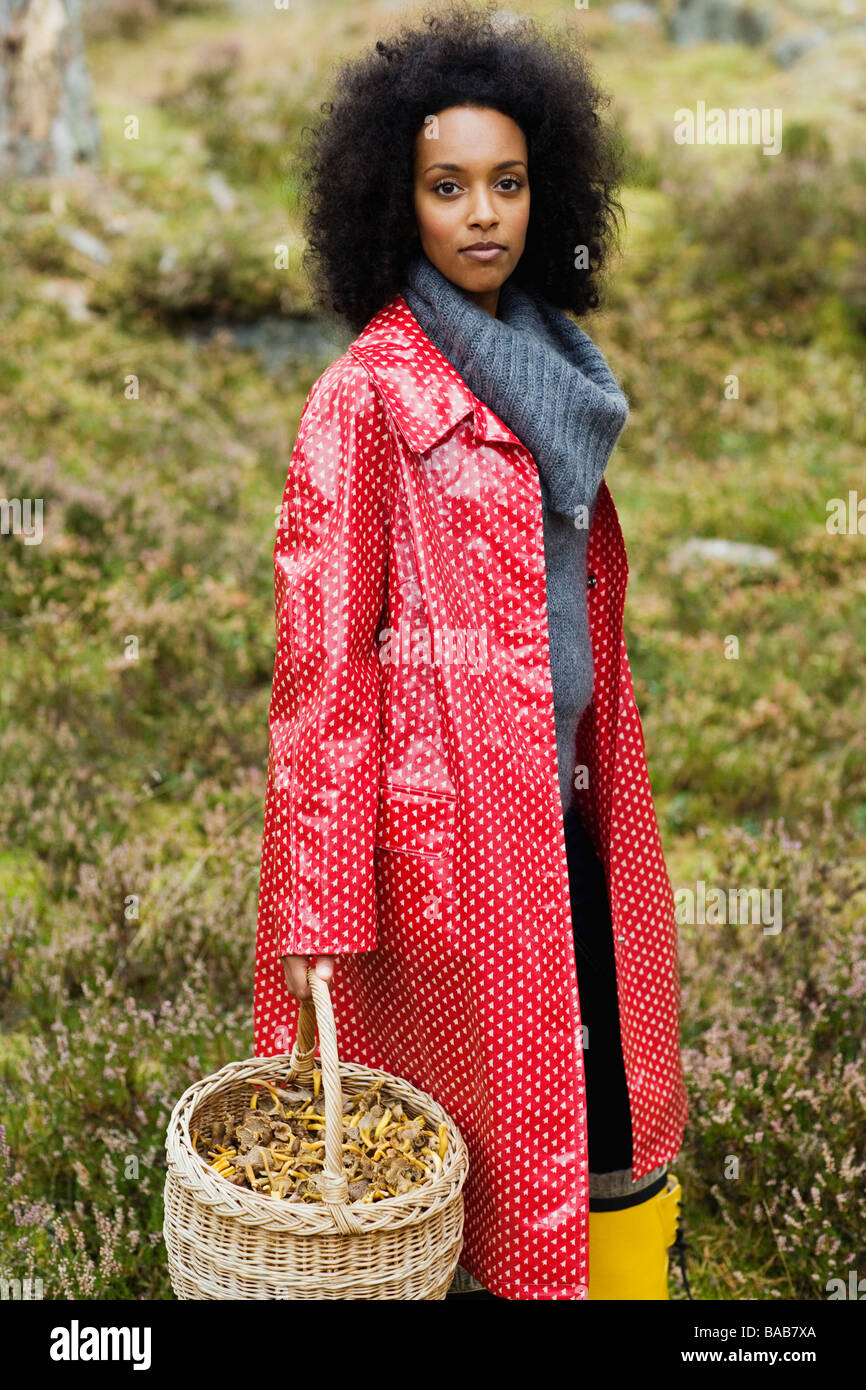 Portrait of a woman wearing a red raincoat, Sweden. Stock Photo