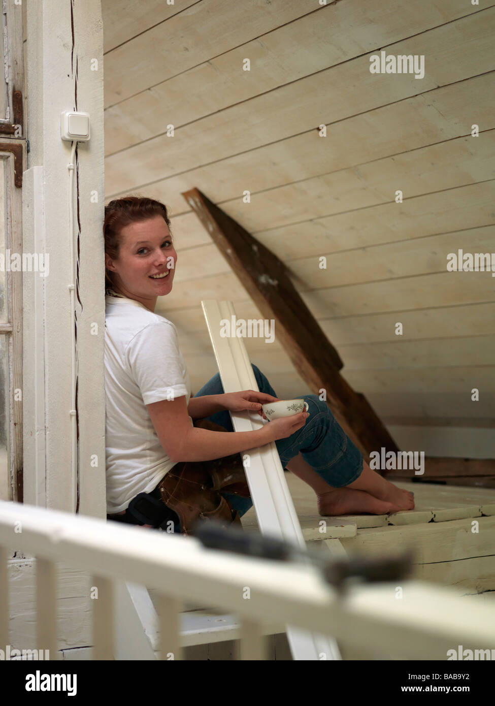 A young woman renovating Sweden. Stock Photo