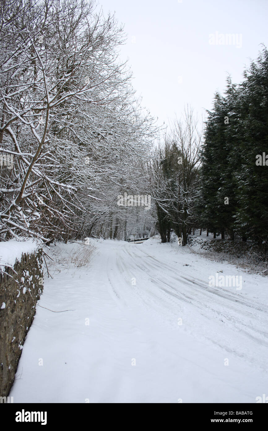 Snow covered Cotswold country lane Stock Photo