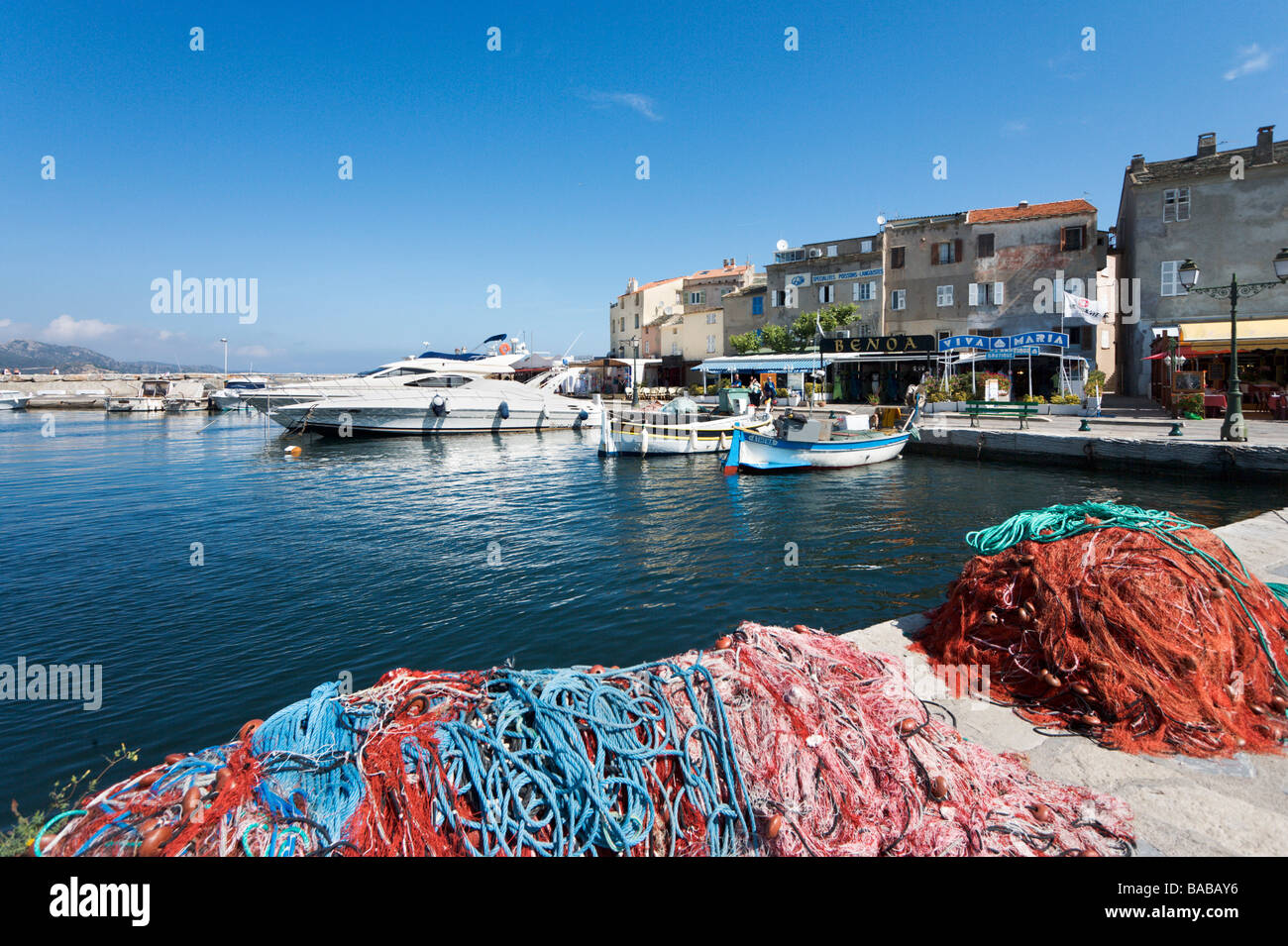 Luxury yachts and fishing boats in the harbour at St Florent, The Nebbio, Corsica, France Stock Photo
