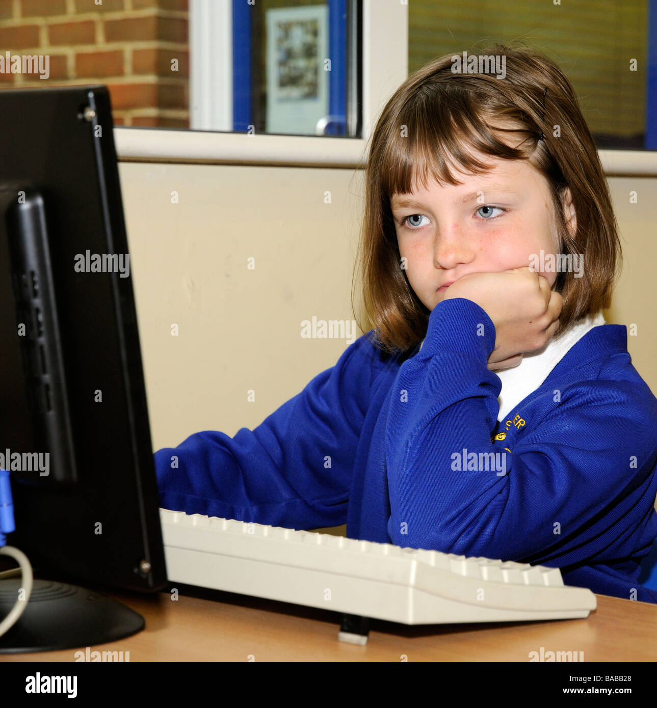 Schoolgirl using a classroom computer Stock Photo - Alamy