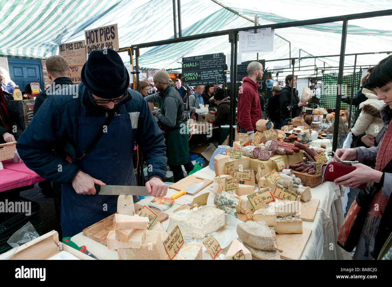 Continental cheeses on market stall in Broadway Market, Hackney, London