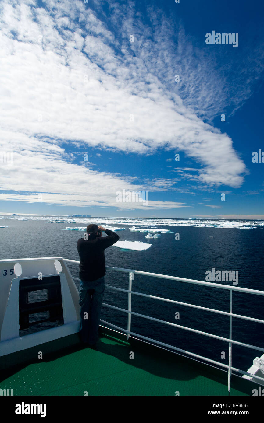 Tourist on cruise ship photographing pack ice and tabular icebergs Antarctic Peninsula near Paulet Island Antarctica Stock Photo