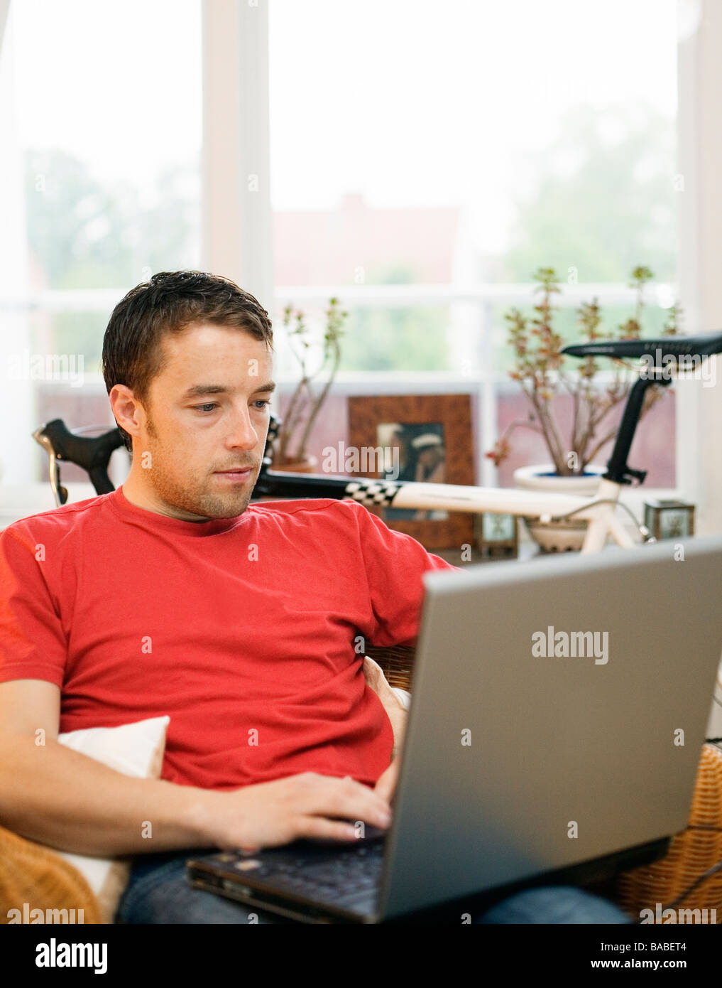 A man with a computer in an appartment Sweden Stock Photo