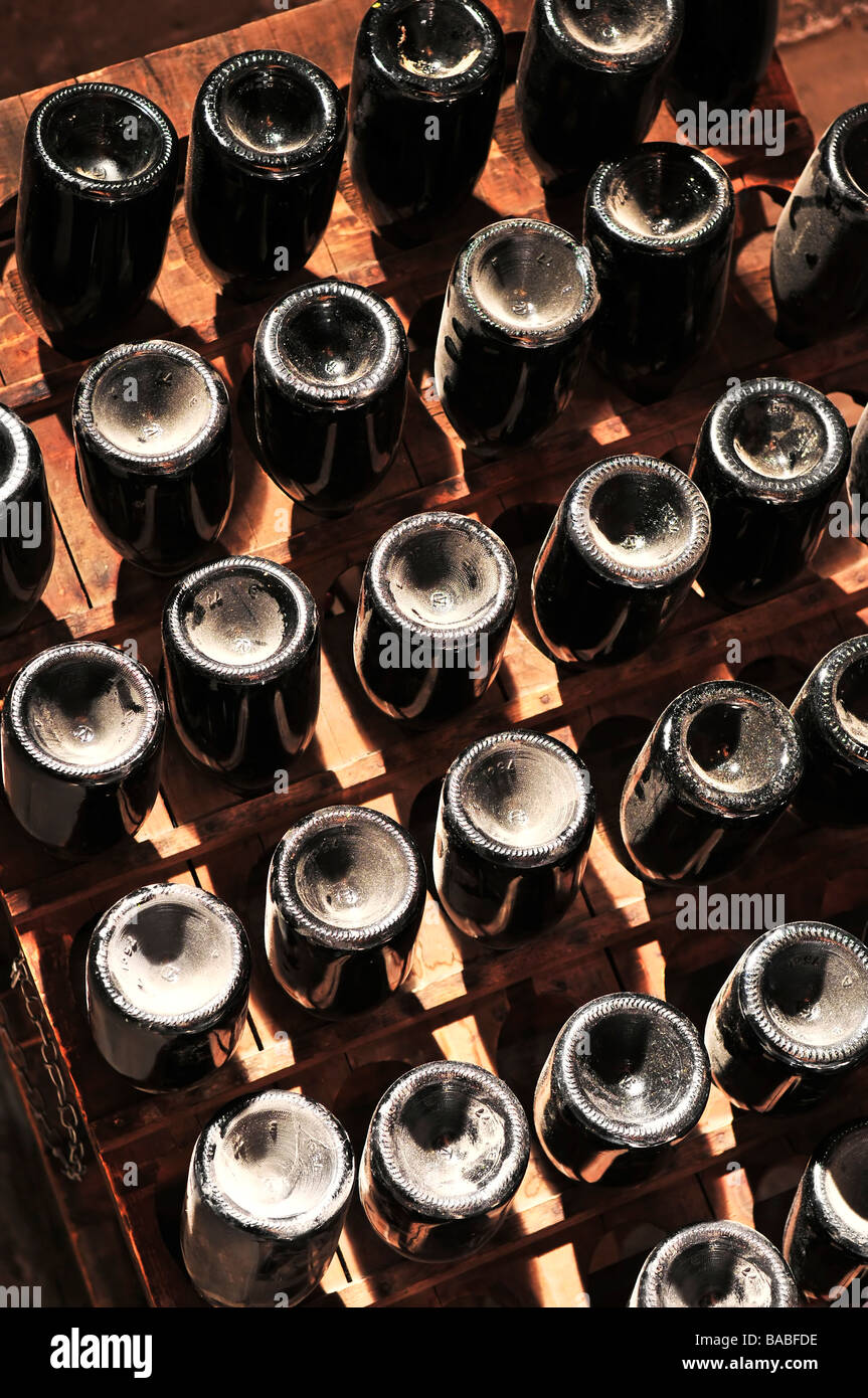 Upside down wine bottles maturing in wooden racks Stock Photo Alamy