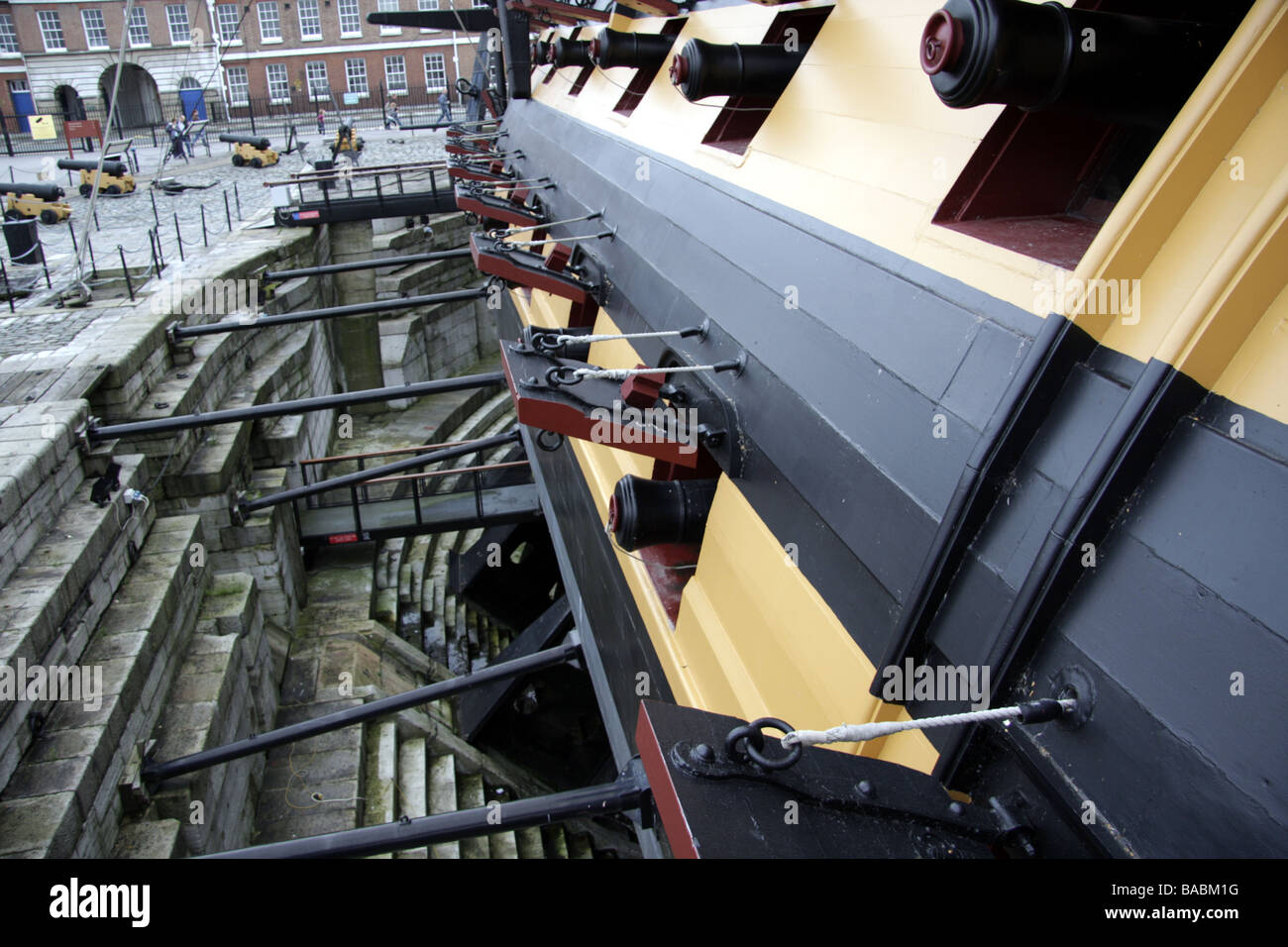 Cannons poking through gun ports on HMS Victory at the Royal Navy Historic Dockyard in Portsmouth Stock Photo