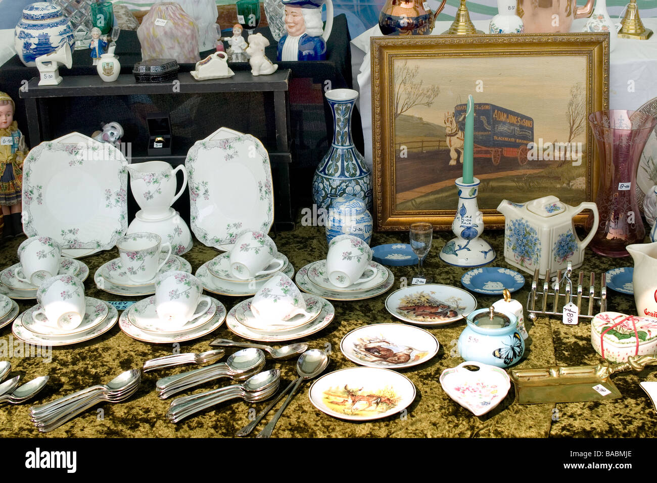 A display of china cutlery and bric a brac on a market stall Stock Photo