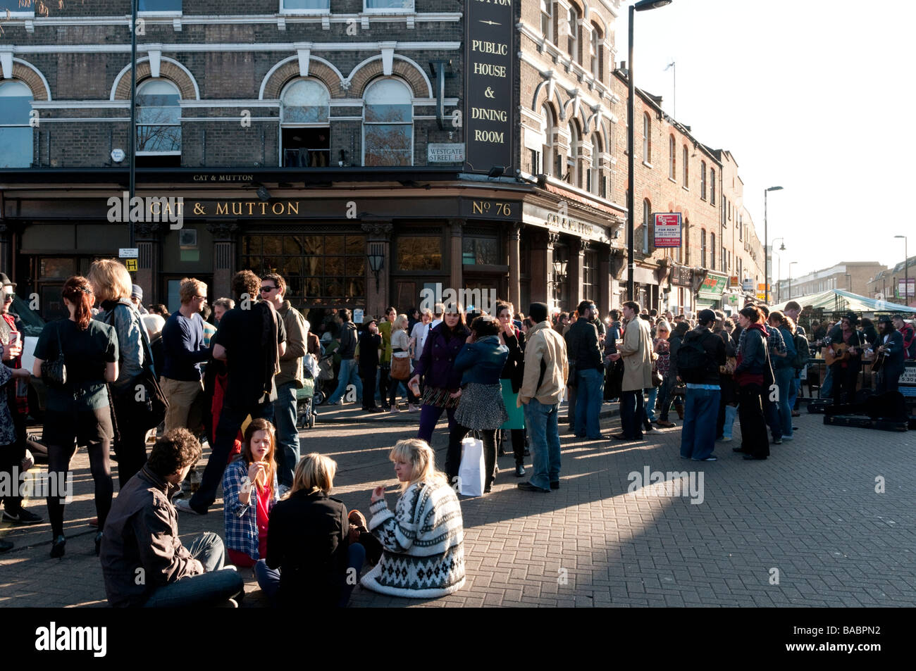 Young people drinking outside the Cat and Mutton pub on the corner of Broadway Market, Hackney, London, UK Stock Photo