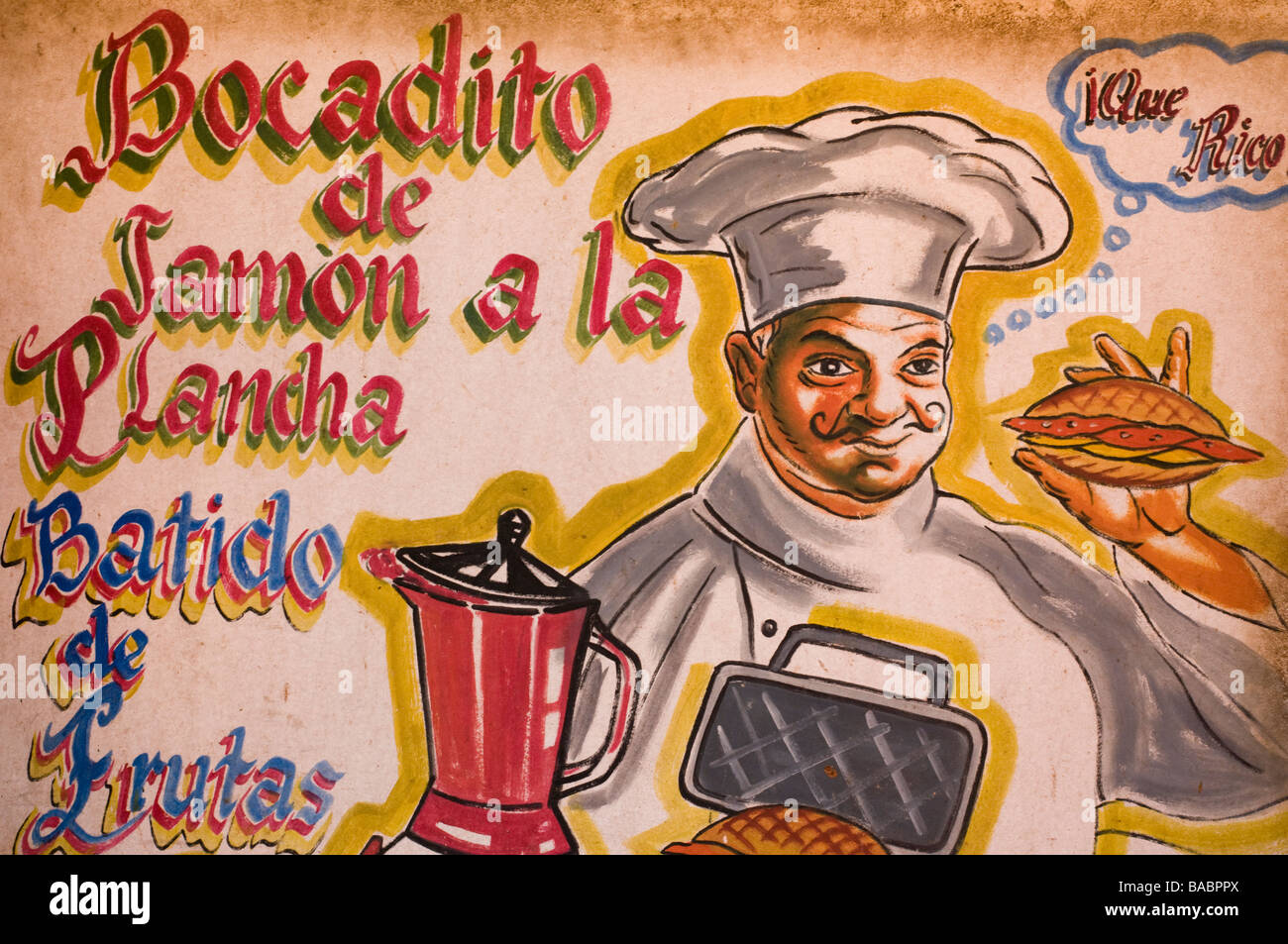 Advertising sign for a sandwich shop in Trinidad, Cuba encouraging the purchase of ham sandwiches with a fruit milkshake. Stock Photo