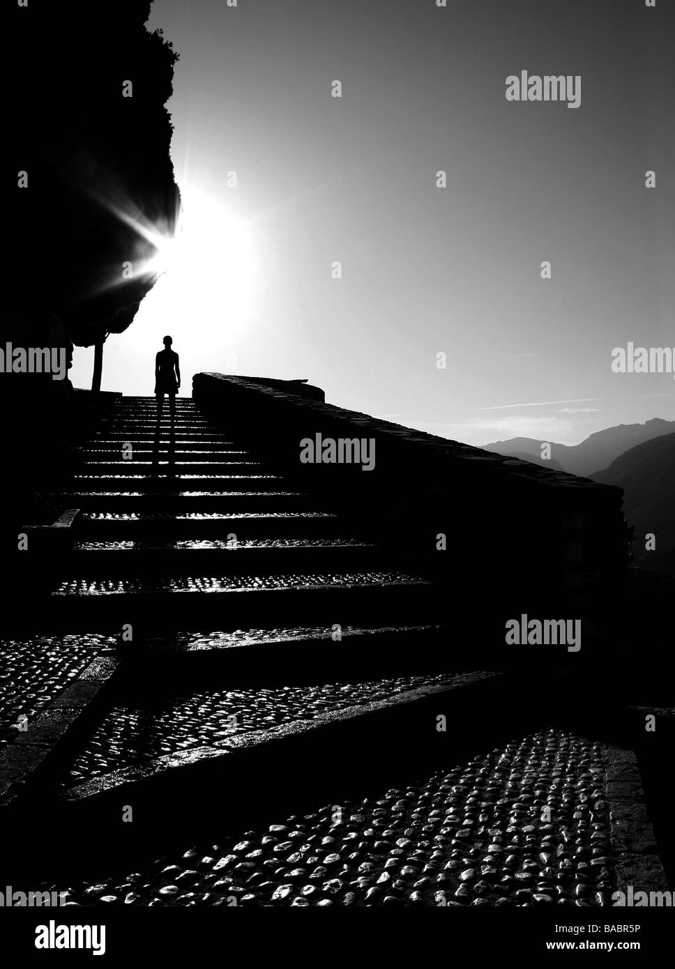 Silhouetted figure on staircase Stock Photo