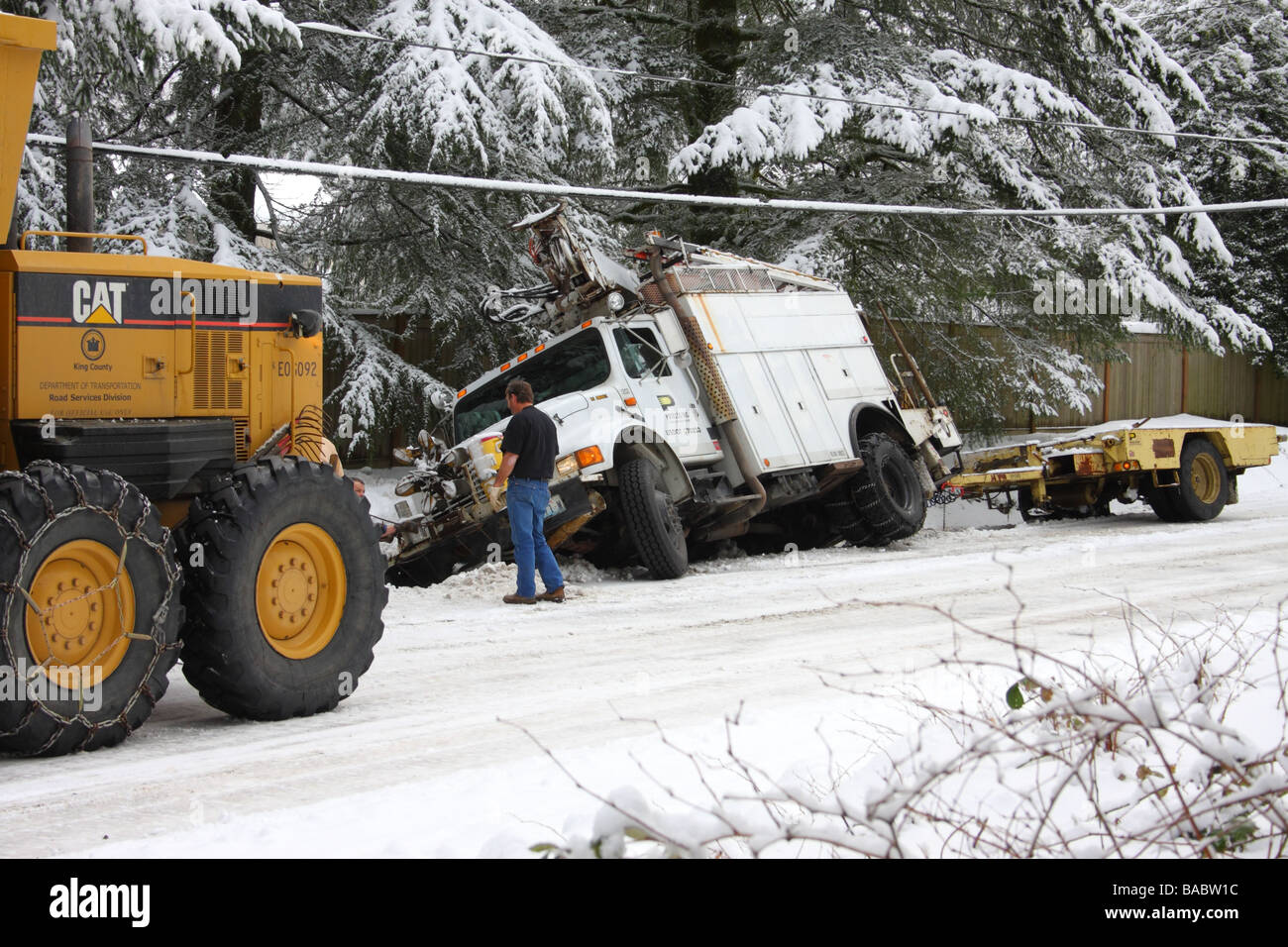 Utility truck pulling trailer slid hires stock photography and images