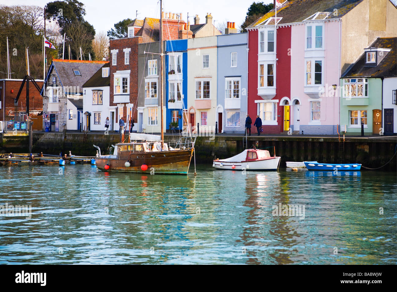 A row of colourful terraced houses on the quay. The old harbour