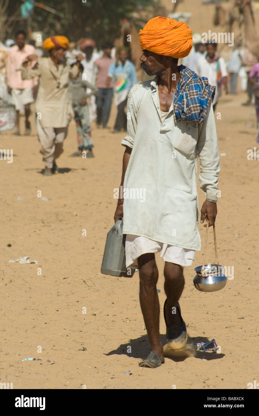 Man in orange turban at Pushkar camel fair Stock Photo