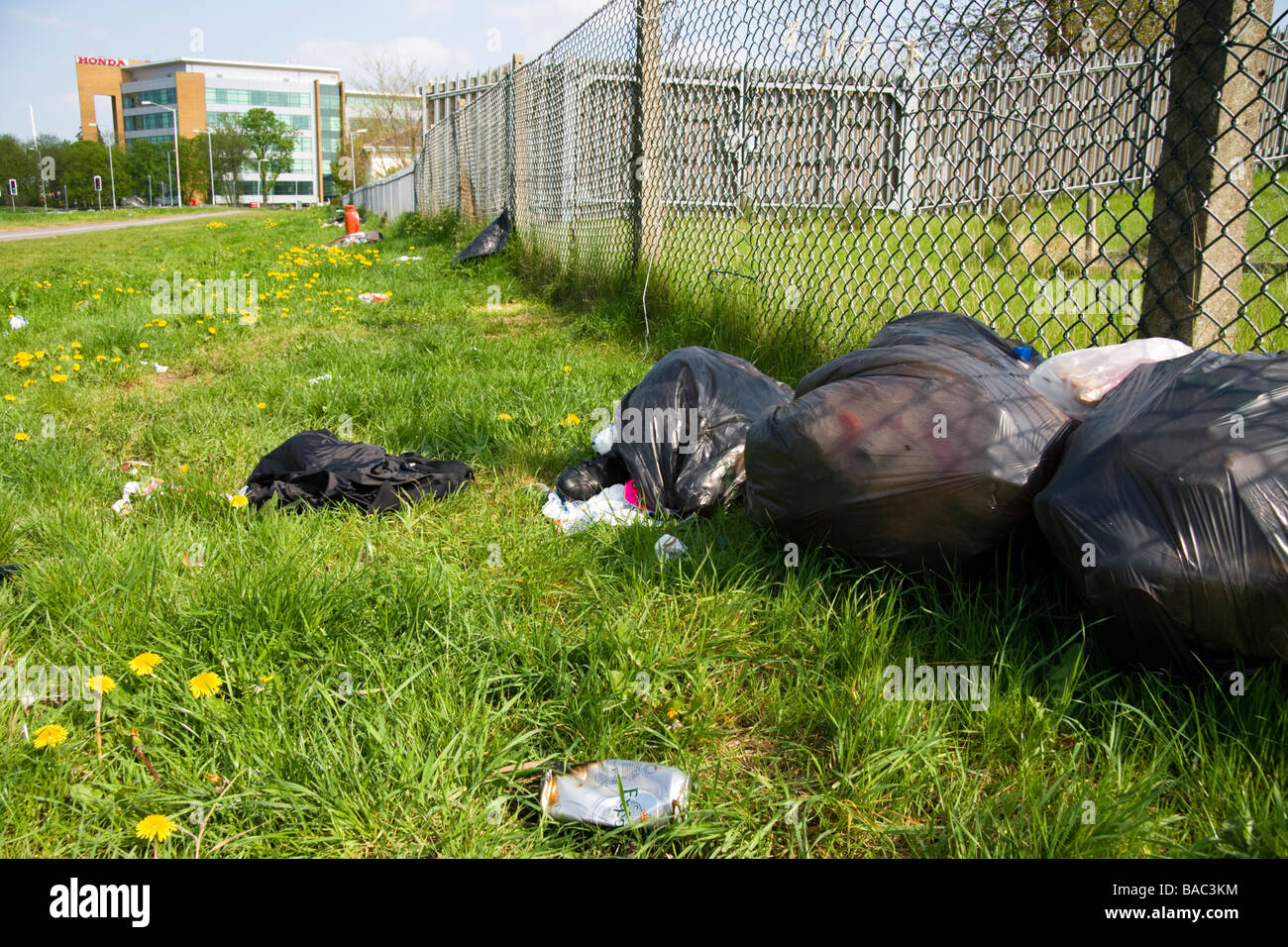 Fly tipped rubbish and junk left by the side of a road in Berkshire UK Stock Photo