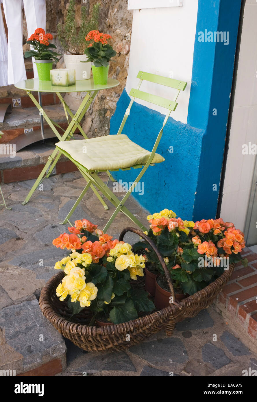 Orange and yellow begonia plants in basket in Marbella old town Stock Photo