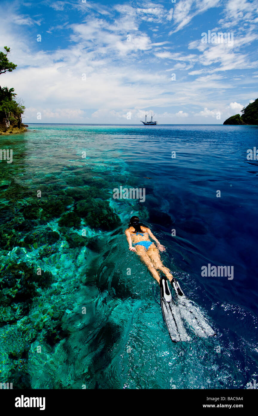 Snorkeling in Raja Empat, Papua, Indonesia, female diver, bikini, clear water, shallow water,  fotosub, great visibility, ocean Stock Photo