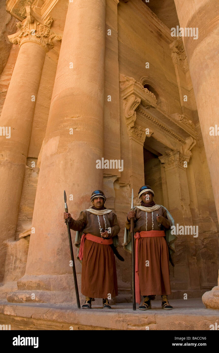 Jordanian men dressed as Nabatean warriors at the entrance to the Khazneh in the ancient Nabatean city of Petra Jordan Stock Photo
