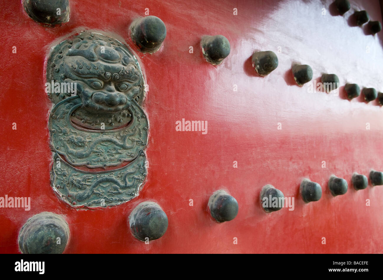 Massive decorative door guards the Forbidden Palace, Beijing, China Stock Photo