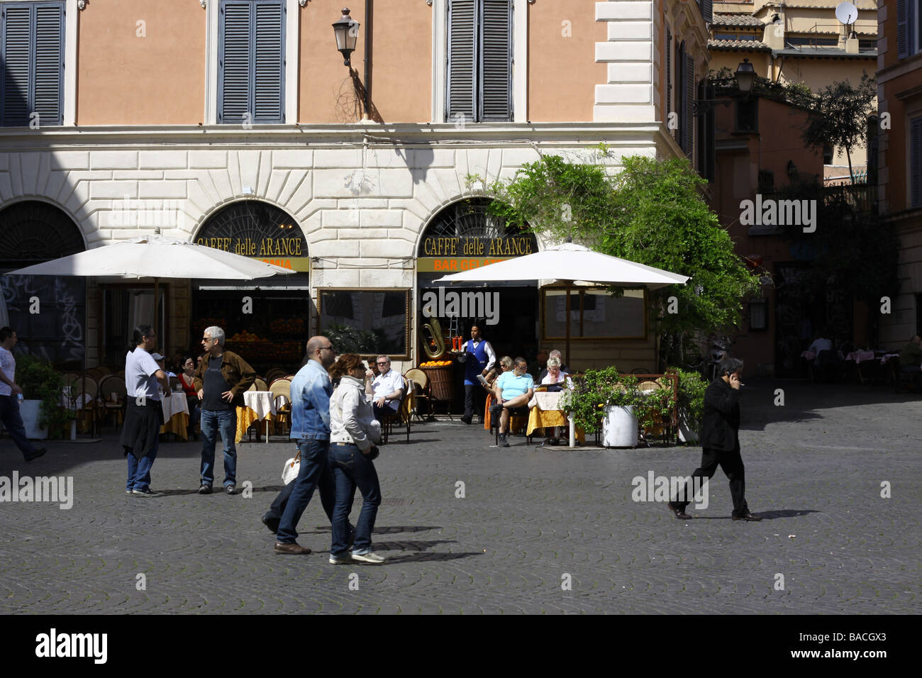 Tourists at a bar on Santa Maria in Trastevere square, Rome, Italy. Stock Photo