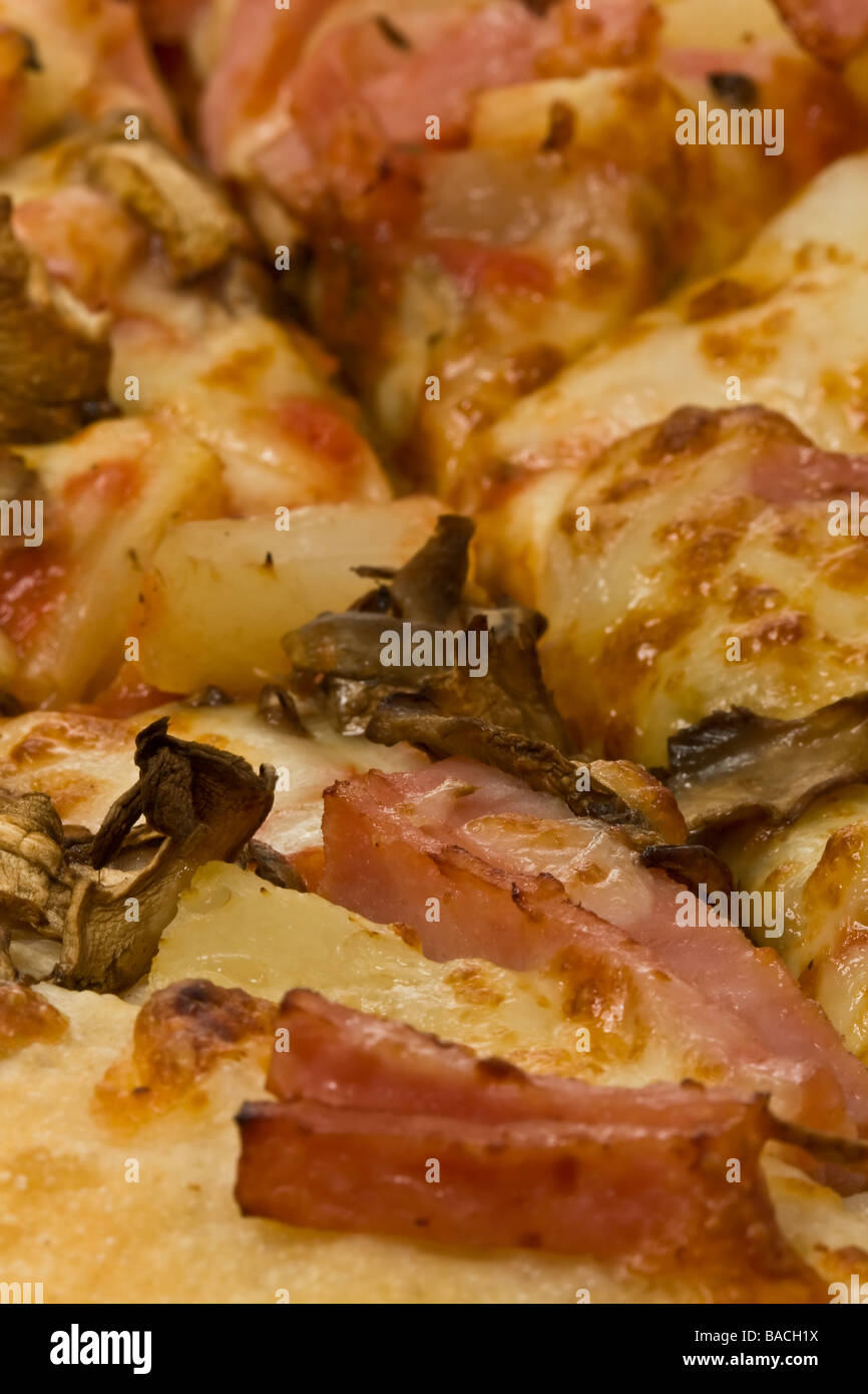 Close up of pizza topping with mushrooms, ham and pineapple Stock Photo