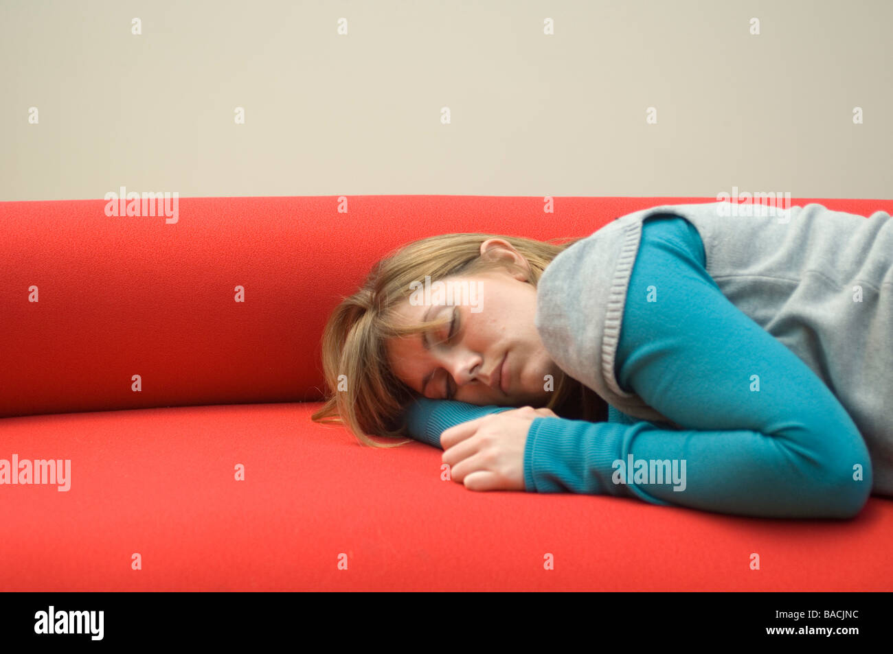 Mid adult woman sleeping on a couch Stock Photo - Alamy