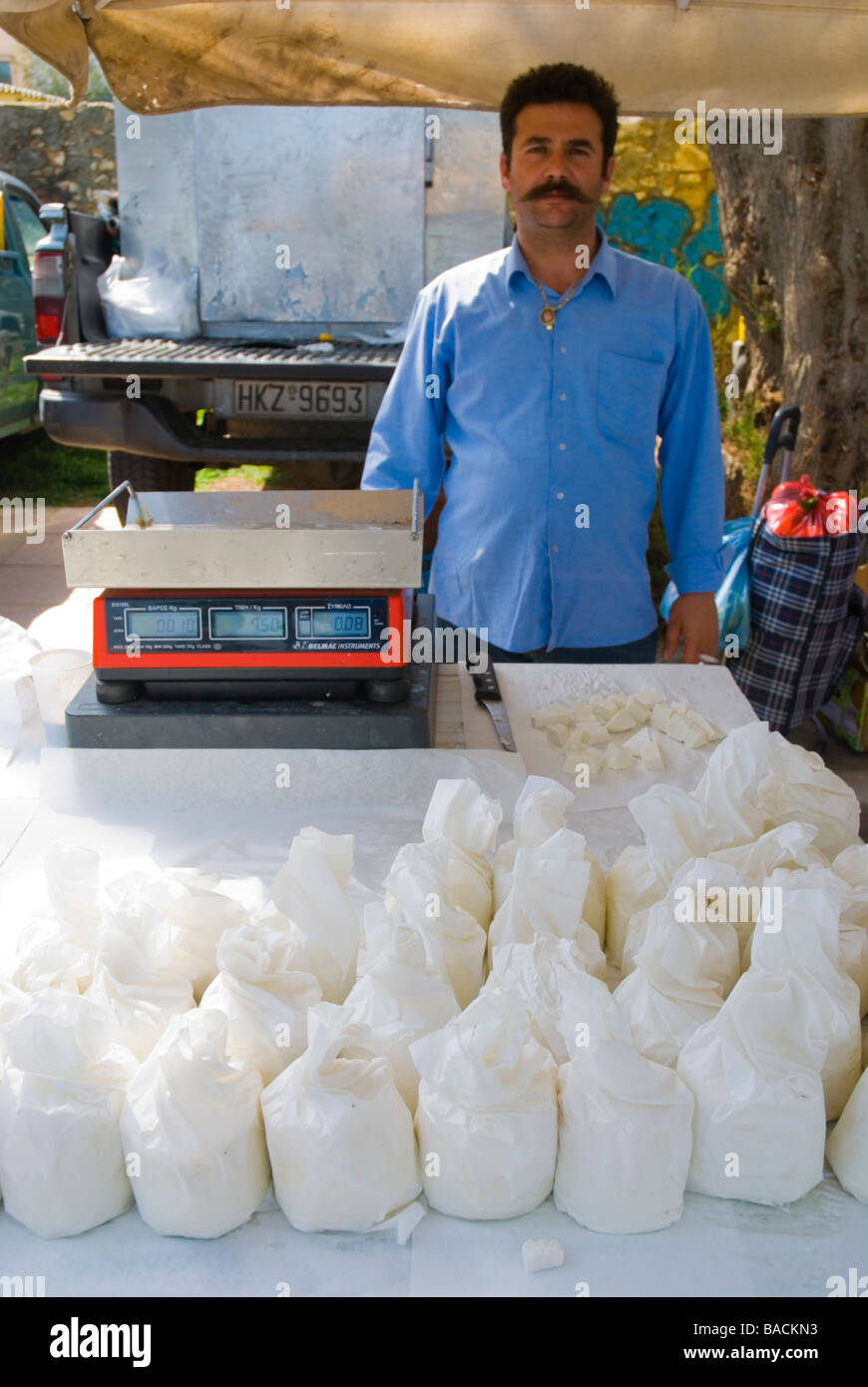 Seller of local goat cheese at the seaside street market in Hania Crete