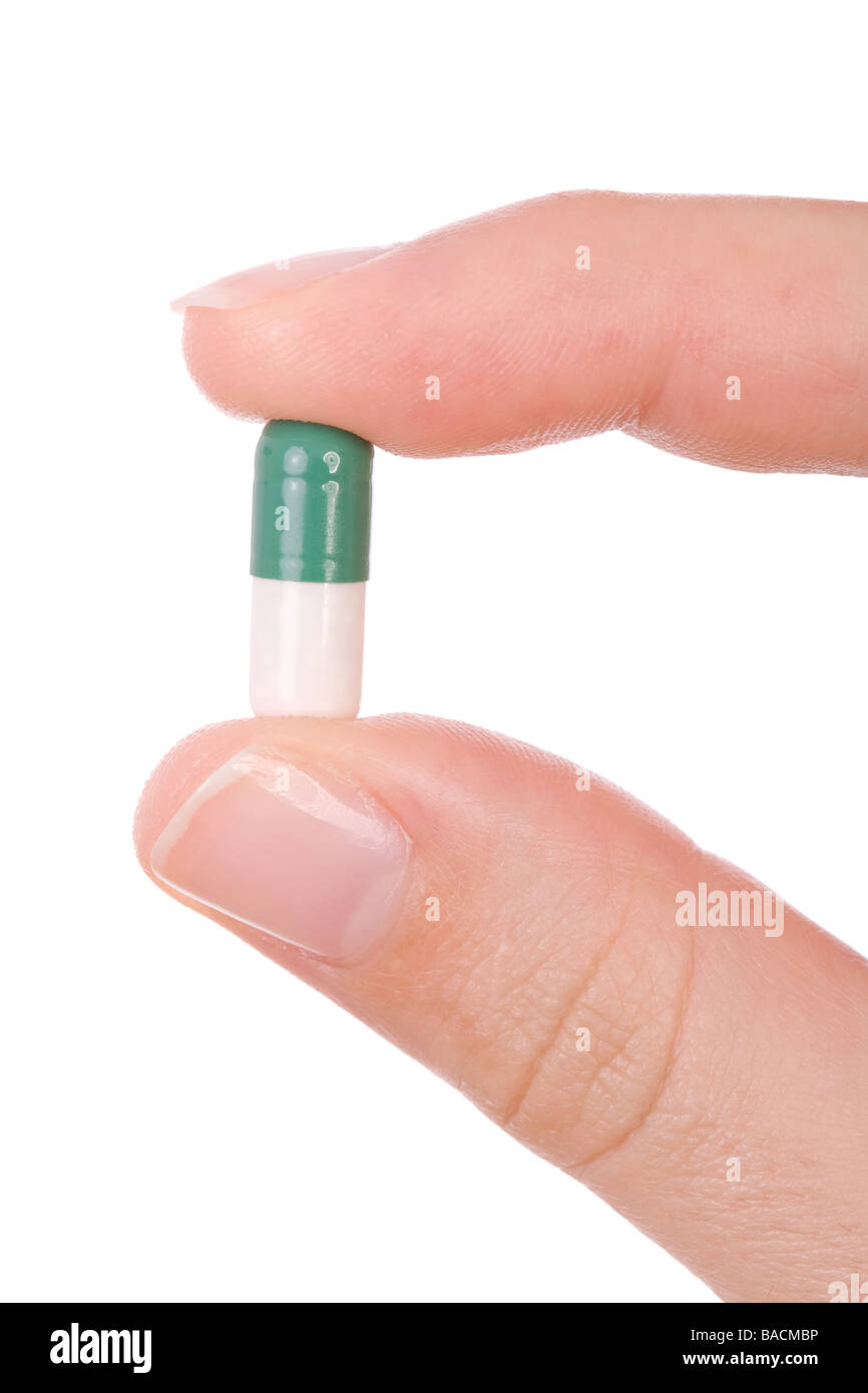 Hand holding a capsule or pill isolated on white Stock Photo Alamy