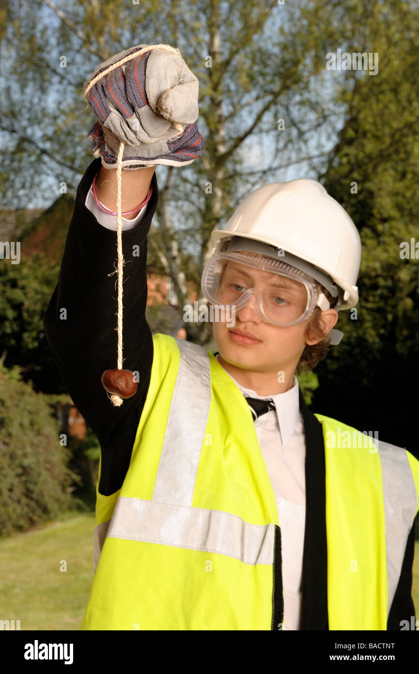 Schoolboy playing conkers Stock Photo