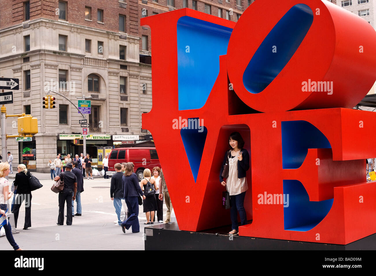 United States, New York City, Manhattan, 6th Avenue, Love sculpture by Robert Indiana with a Japanese tourist Stock Photo